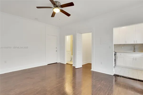 a bedroom with furniture and a flat screen tv