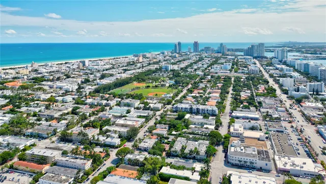 an aerial view of residential houses with city view