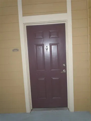 a view of a hallway with a wooden door