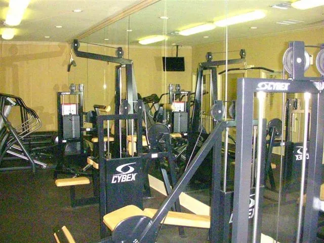 a sign board with a play ground in the back