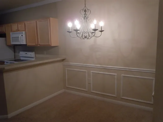 a view of a room with an empty space and a sink