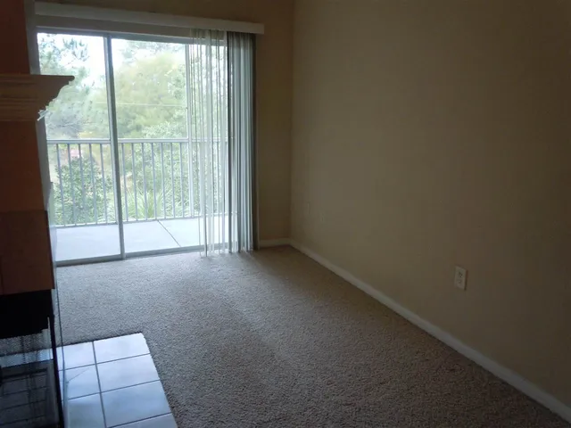 a view of an empty room and fire place