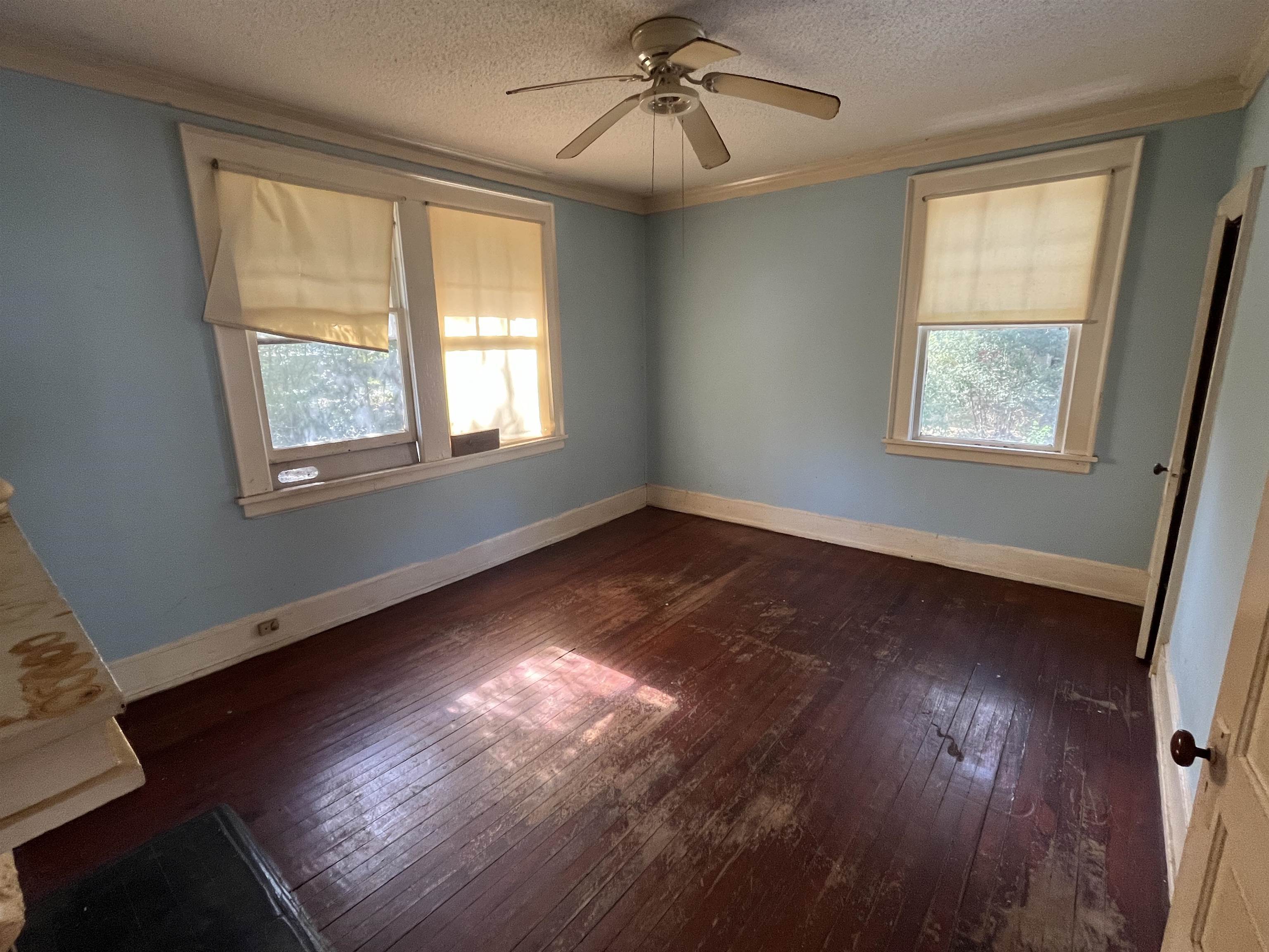 211 4th Street Mobile, AL 36611 - Photo 29 of 34 Unfurnished bedroom with dark wood-style flooring, ceiling fan, crown molding, and a textured ceiling