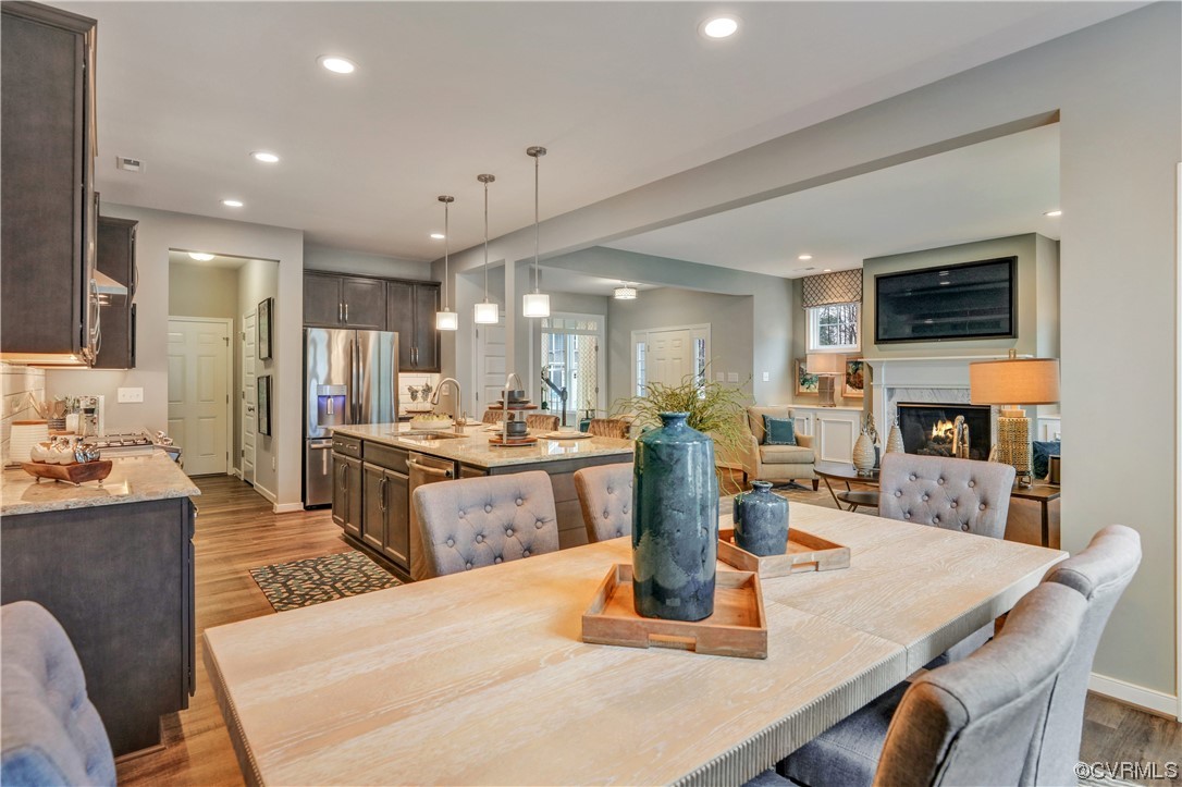 18637 Palisades Ridge Moseley, VA 23120 - Photo 14 of 41 a kitchen with a dining table chairs and refrigerator