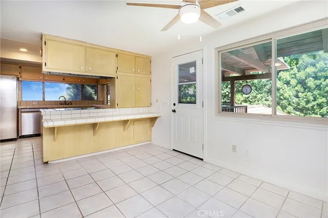 a kitchen with stainless steel appliances granite countertop a sink and cabinets