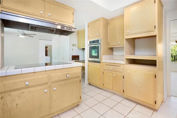 a kitchen with stainless steel appliances a sink and cabinets