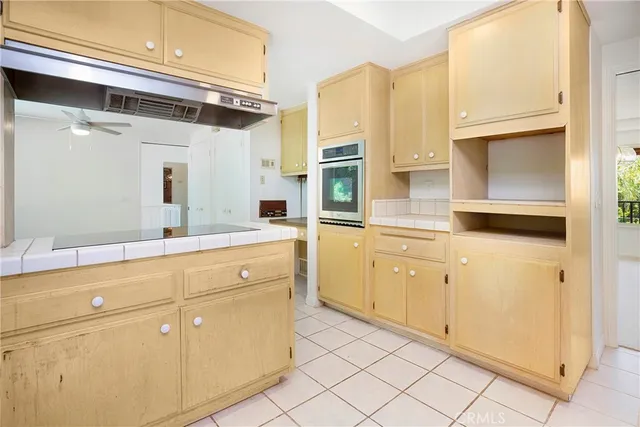 a kitchen with stainless steel appliances a sink and cabinets