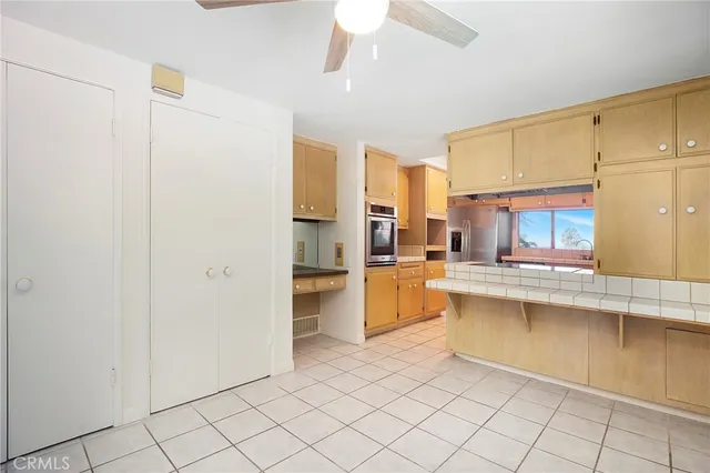 a kitchen with stainless steel appliances kitchen island granite countertop a sink and white cabinets