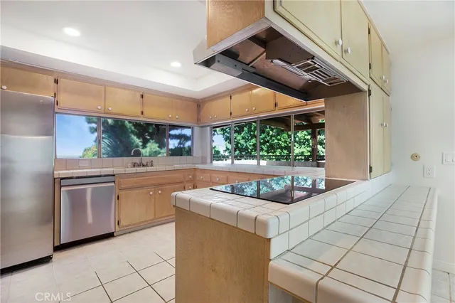 a view of a room with a chandelier and large windows
