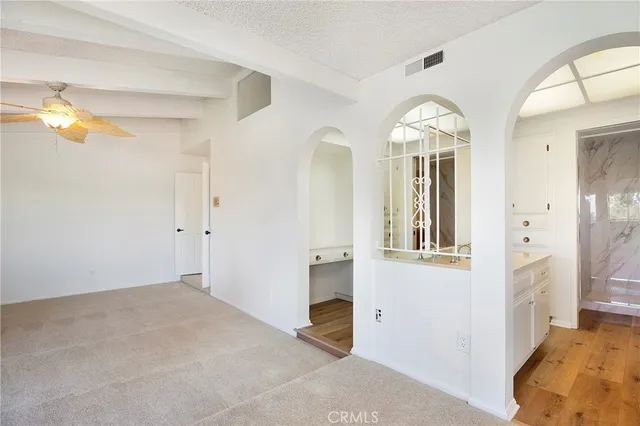 a bathroom with a tub sink and mirror