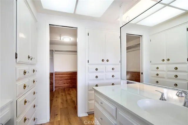 a view of a kitchen with wooden cabinets and a window