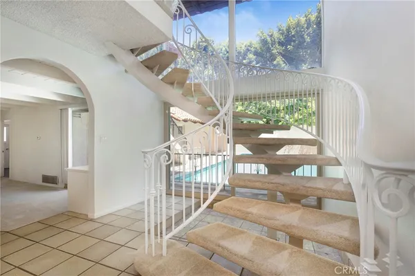 a view of a room with gym equipment and a window