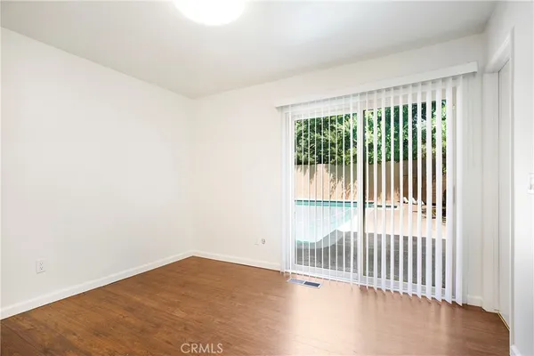an empty room with wooden floor