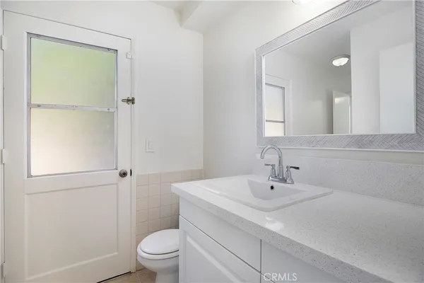 an empty room with a window and a ceiling fan