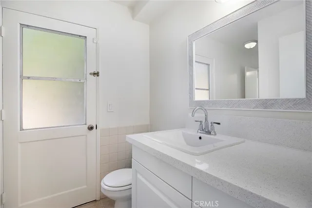 an empty room with a window and a ceiling fan