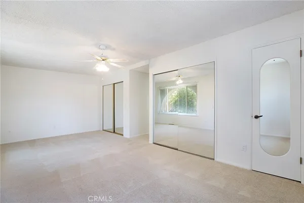 an empty room with windows and closet