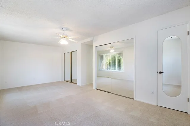 an empty room with windows and closet