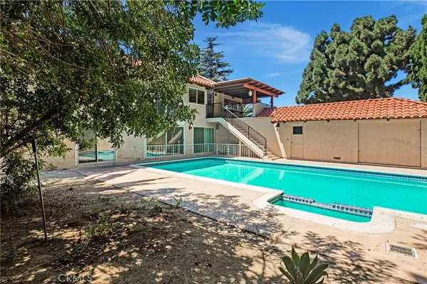 a view of a house with a yard and tree s