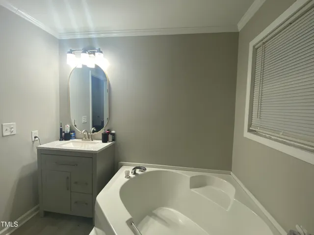 a bathroom with a sink mirror vanity and toilet