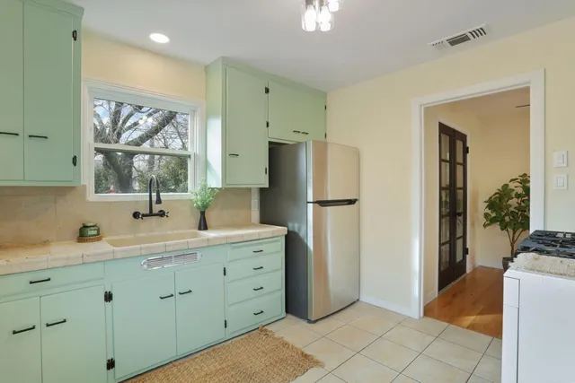 a kitchen with a refrigerator and a sink