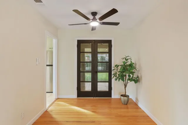 a view of a room with wooden floor and fan