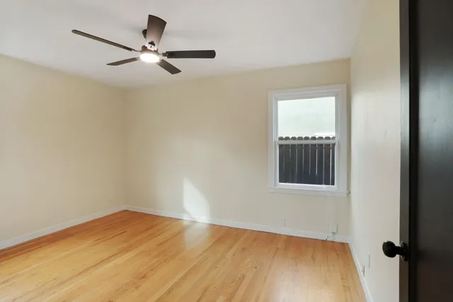 a view of a hallway with dining room and wooden floor