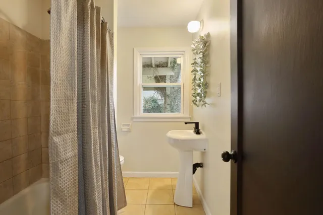 a view of an empty room with glass door and wooden floor