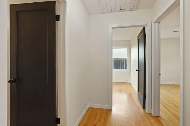 a view of an empty room with a fireplace and a window