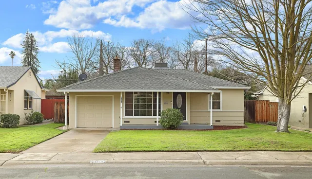 a front view of a house with a garden