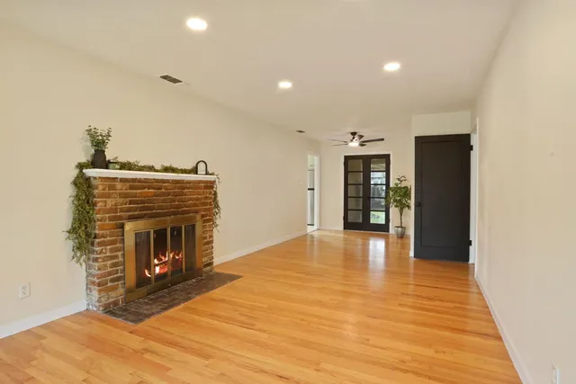 a view of a house with backyard and a tree