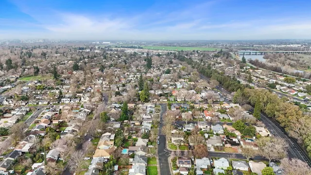 a view of a lake with boats and trees all around