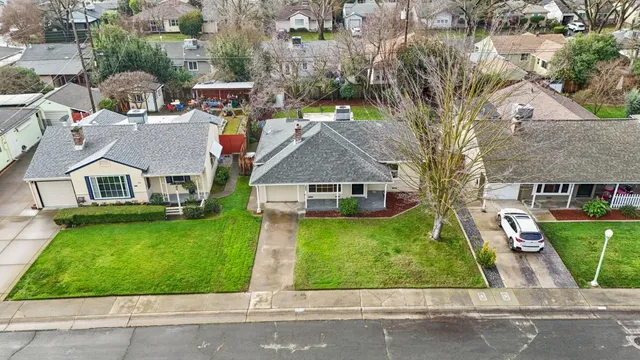 an aerial view of residential houses with yard