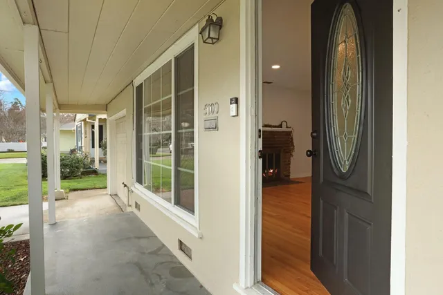 a view of a hallway with wooden floor and door
