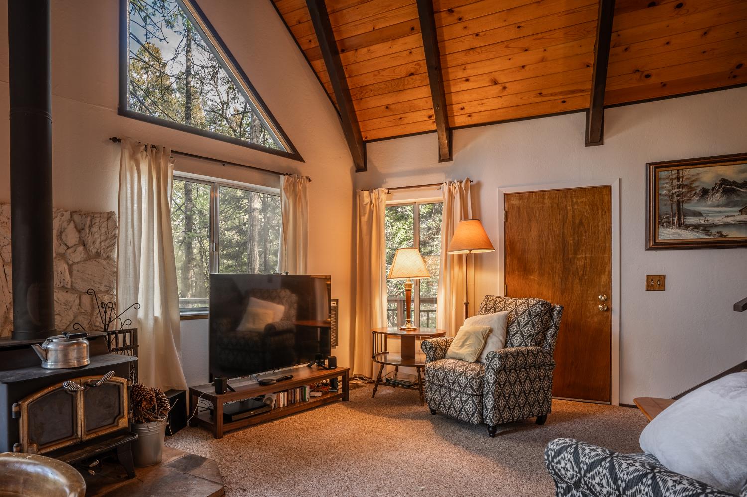 3790 Apache Road Arnold, CA 95223 - Photo 6 of 41 a living room with furniture a flat screen tv and floor to ceiling window