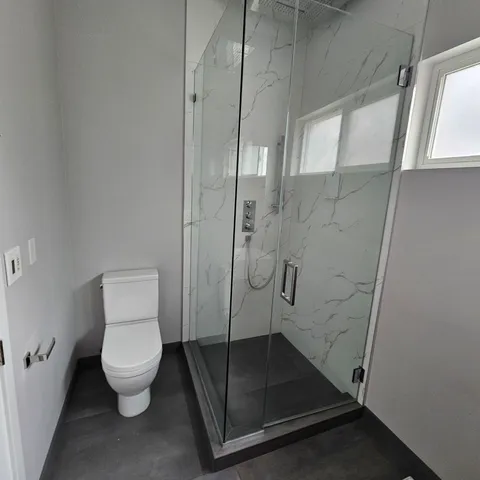 a bathroom with a granite countertop toilet
