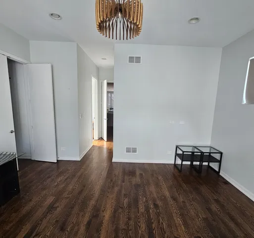 a view of a room with wooden floor and a cabinet