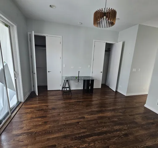 an empty room with wooden floor and window