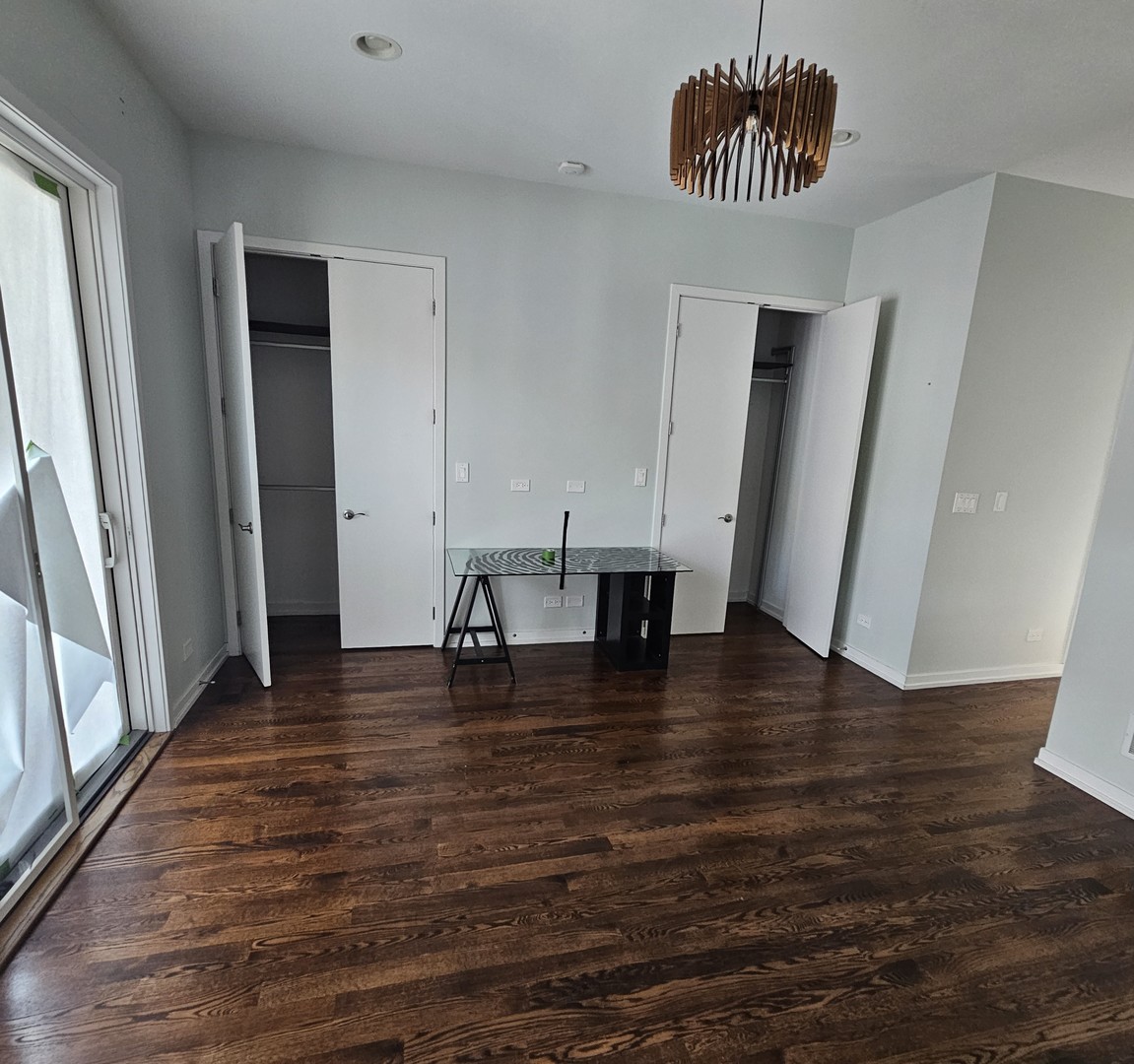 1013 North Honore Street, Unit 1 Chicago, IL 60622 - Photo 7 of 17 an empty room with wooden floor and window