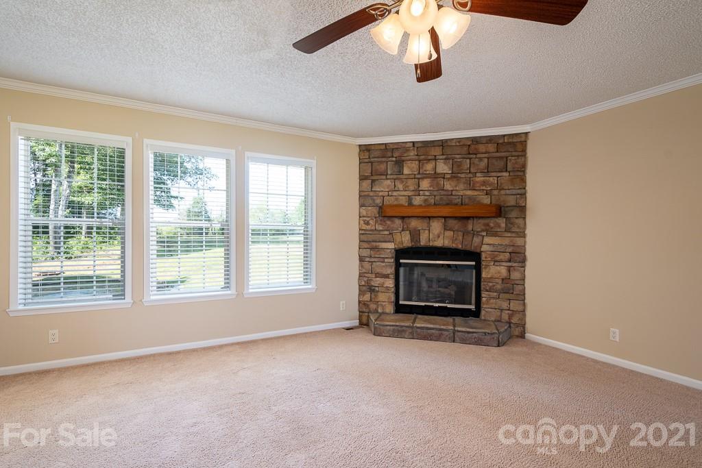 6621 Love Point Road Denver, NC 28037 - Photo 14 of 26 a living room with a fireplace and a large window