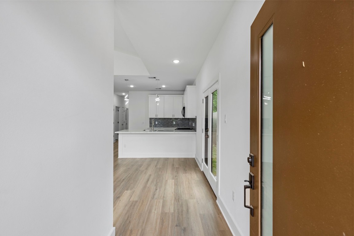 8109 Hamlet Street, Unit B Houston, TX 77078 - Photo 2 of 21 a view of a hallway with wooden floor and a kitchen