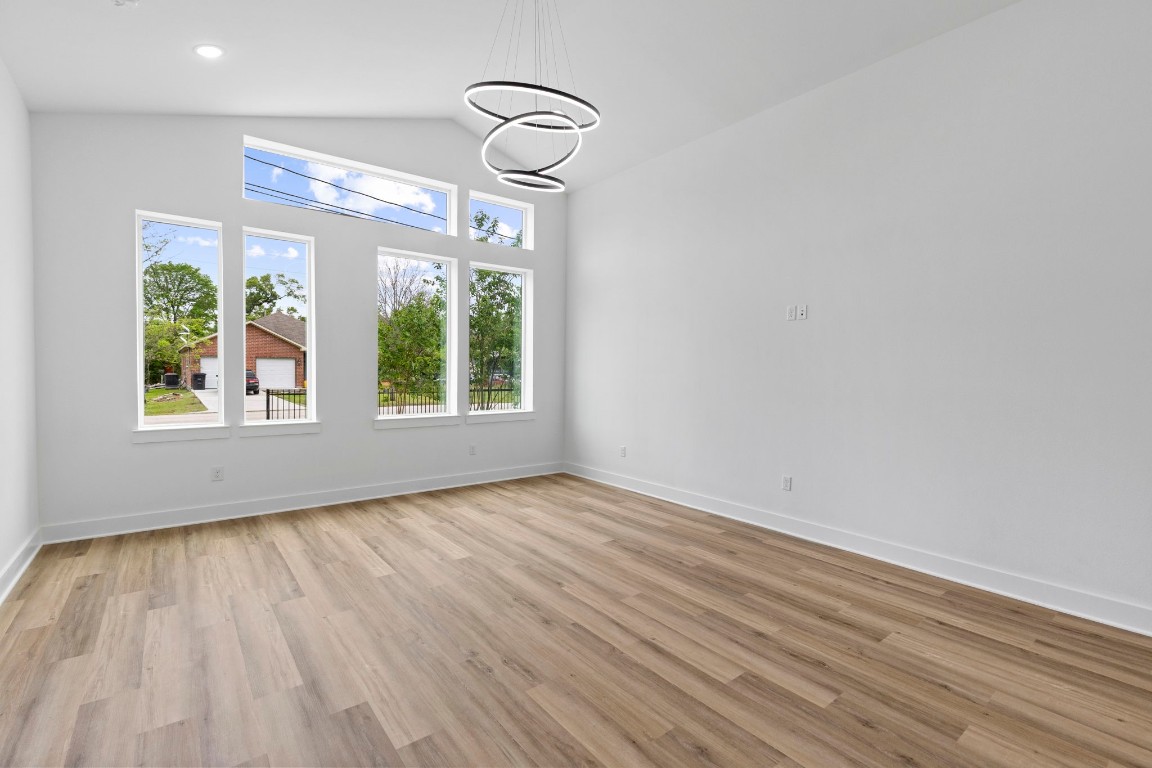 8109 Hamlet Street, Unit B Houston, TX 77078 - Photo 4 of 21 a view of an empty room with wooden floor and a window