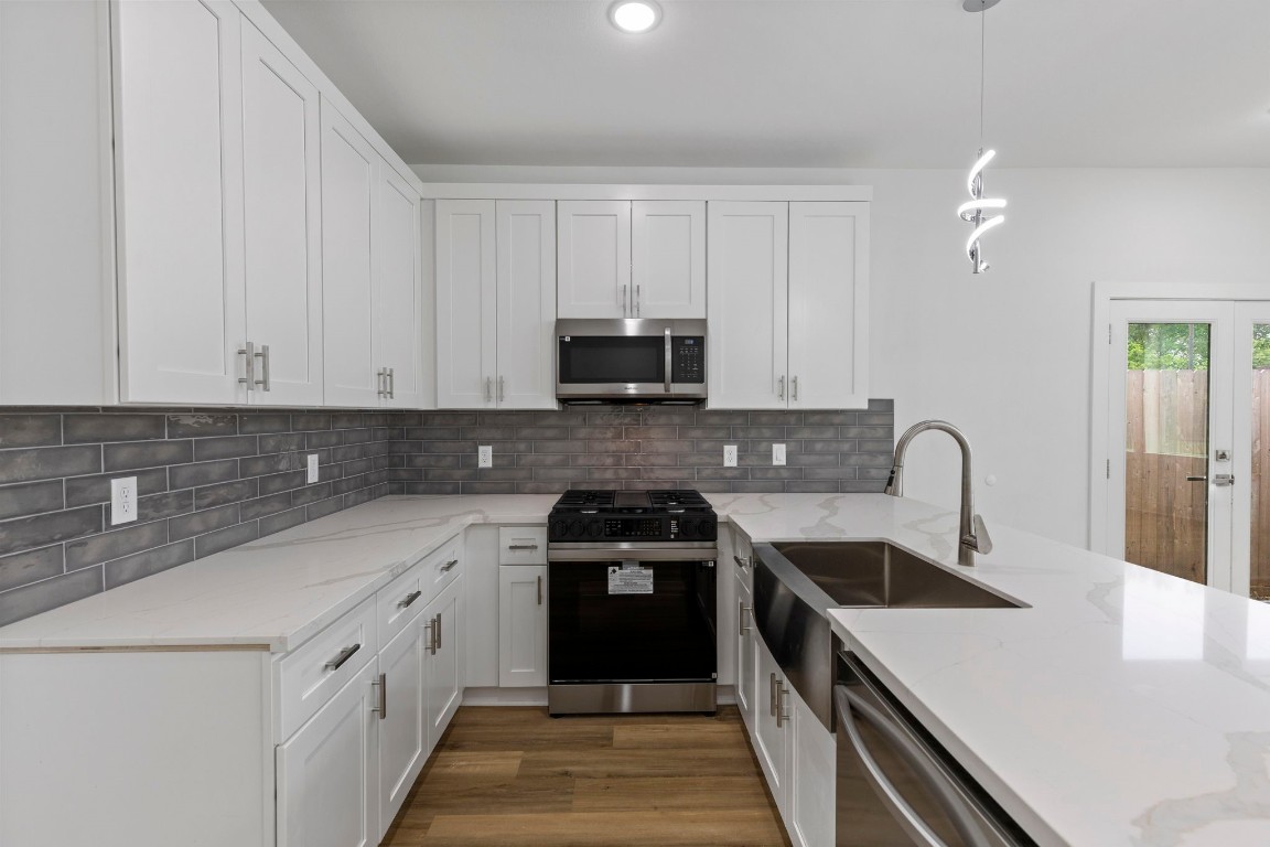8109 Hamlet Street, Unit B Houston, TX 77078 - Photo 6 of 21 a kitchen with a sink and a stove top oven
