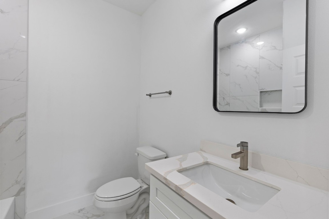 8109 Hamlet Street, Unit B Houston, TX 77078 - Photo 9 of 21 a bathroom with a sink vanity mirror and toilet
