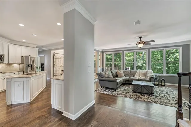 a living room with furniture and large windows