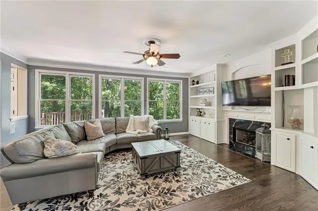 a living room with furniture fireplace and flat screen tv