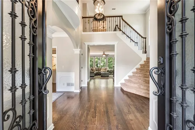 a view of front door with wooden floor and stairs