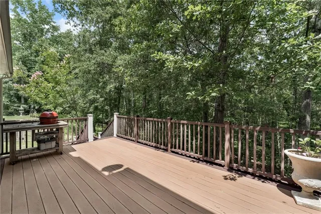 a balcony with wooden floor and fence