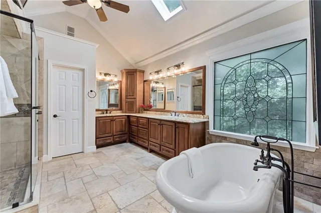 a bathroom with a tub sink and mirror