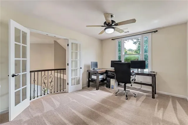 a view of a livingroom with workspace and a window