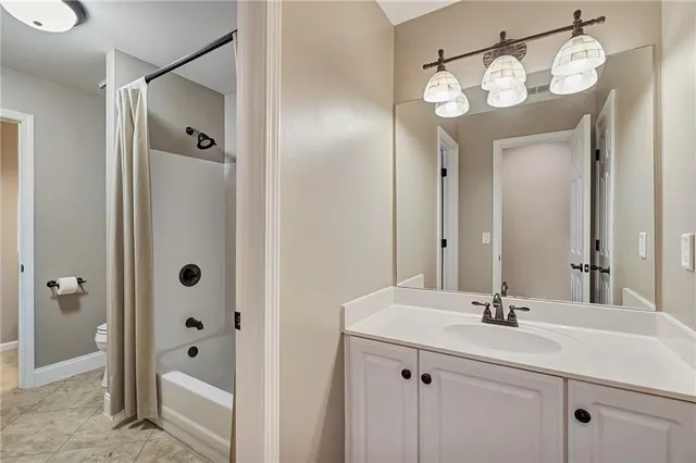 a bathroom with a double vanity sink mirror and shower